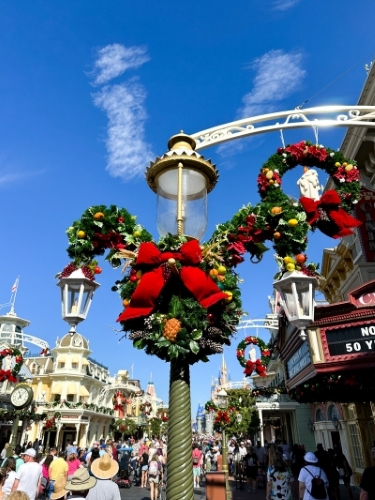 A decorated Mickey wreath on a street light at Magic Kingdom. Visiting theme parks is a great thing to do on Thanksgiving in Orlando.